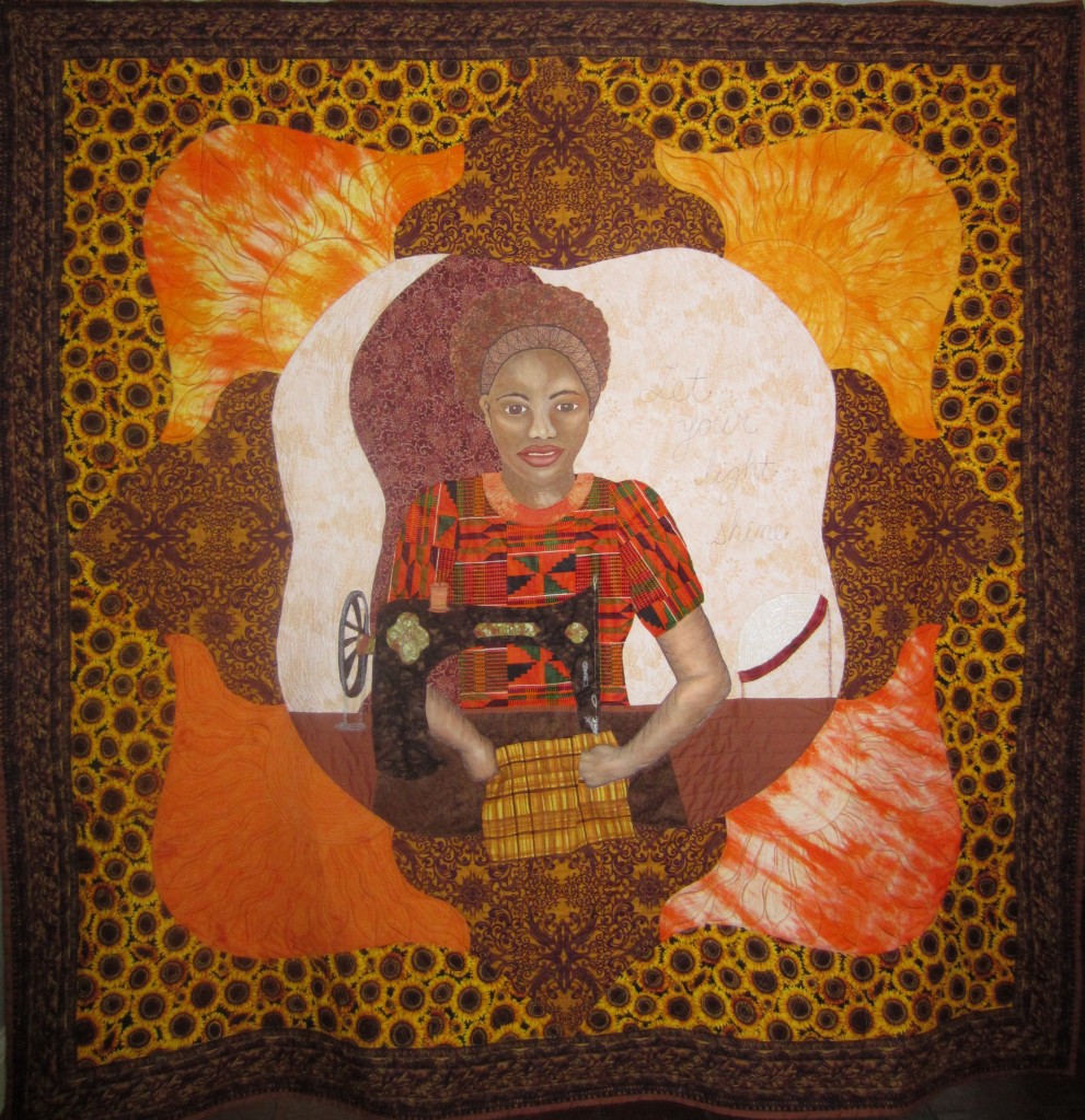 Sewing Sister 2013 72 x 72 Sewing Sister was created for the Solar Sister exhibit under the auspices of Quilt for Change. When I first met Katherine Lucey, Executive Director of Solar Sister, she told me the story of Teddy the Tailor. Before she purchased a solar light, Teddy Namirembe would walk to the nearby village in Uganda to work at night, leaving her three daughters at home. The simple purchase of a solar light brought so many positive changes to her life and her business - she has extra time to work since she does not have to walk to the village and back and so her income has increased 30 percent. She is safer for not having to make the walk and her children are not alone at home. Her children also share in the use of the light to do their homework. She is not paying for renting a work space or for expensive kerosene and they no longer breathe in the kereosene smoke. Like most women, Teddy turns the extra money she makes (she sews school uniforms) back into her family and her business. As the owner of a small quilting business, I can relate to Teddy. I choose to work at home so I can be available to help my children with their homework and take care of my parents. The hours I have to work after dark, after the work of caring for my family is done, are vitally important to my business. Solar Sister is not only important to the entrepreneurs who sell the lights, but to many others who buy the solar lights and phone chargers as a part of their small business.