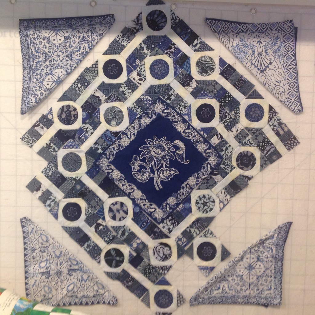 Design wall with quilt blocks in blue and white forming a diamond