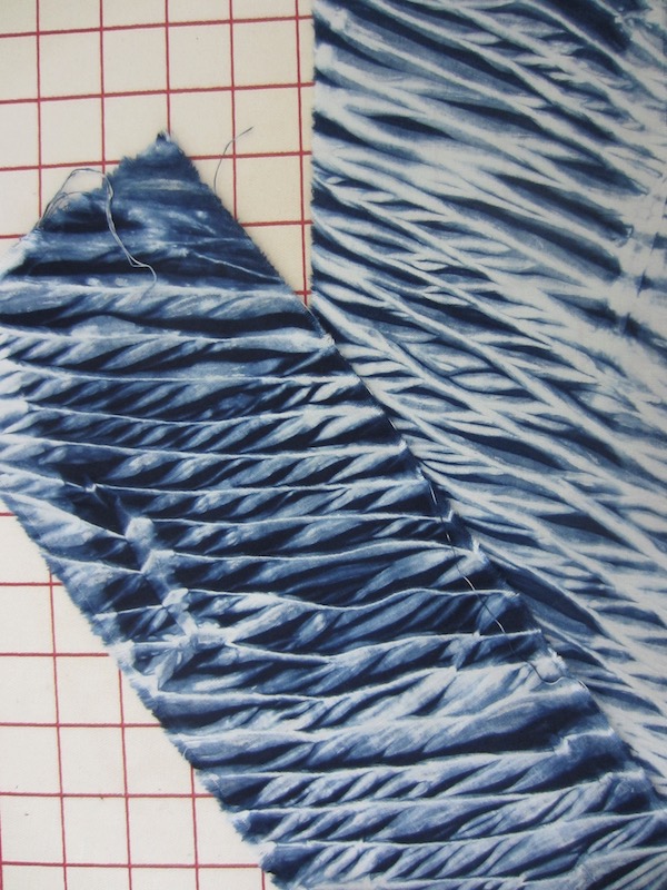 Arashi dyed fabric with blue lines in the shape of feathers
