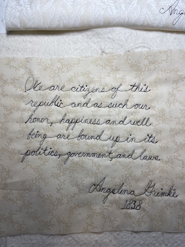 Machine quilted quote, "We are citizens of this republic and as such our honor, happiness and well being are bound up in its politics, government and laws." Angelina Grimke, 1838.