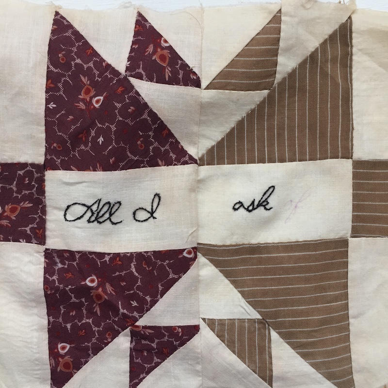Antique shoofly quilt block with words embroidered by hand in black thread. The words read "All I ask"
