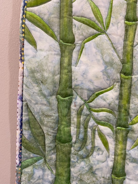 Finished art quilt detail showing shaded bamboo trees