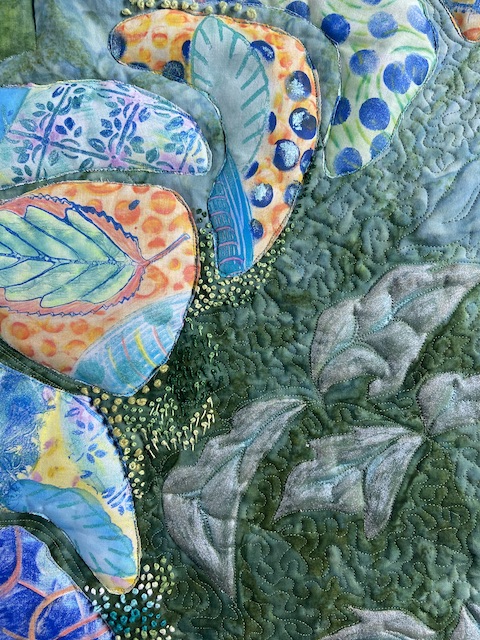 French knots onto an art quilt with a green background and brightly colored stepping stones