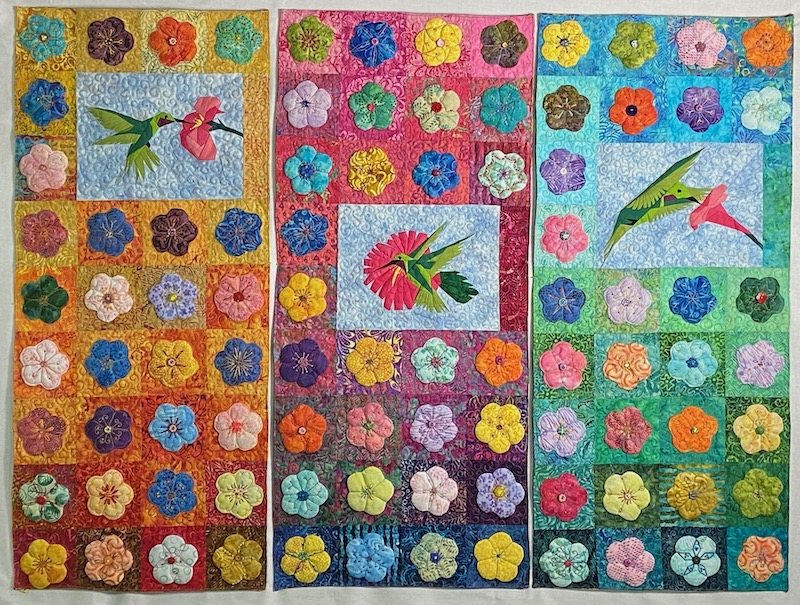 Art quilt of flowers and hummingbirds by Allison Wilbur