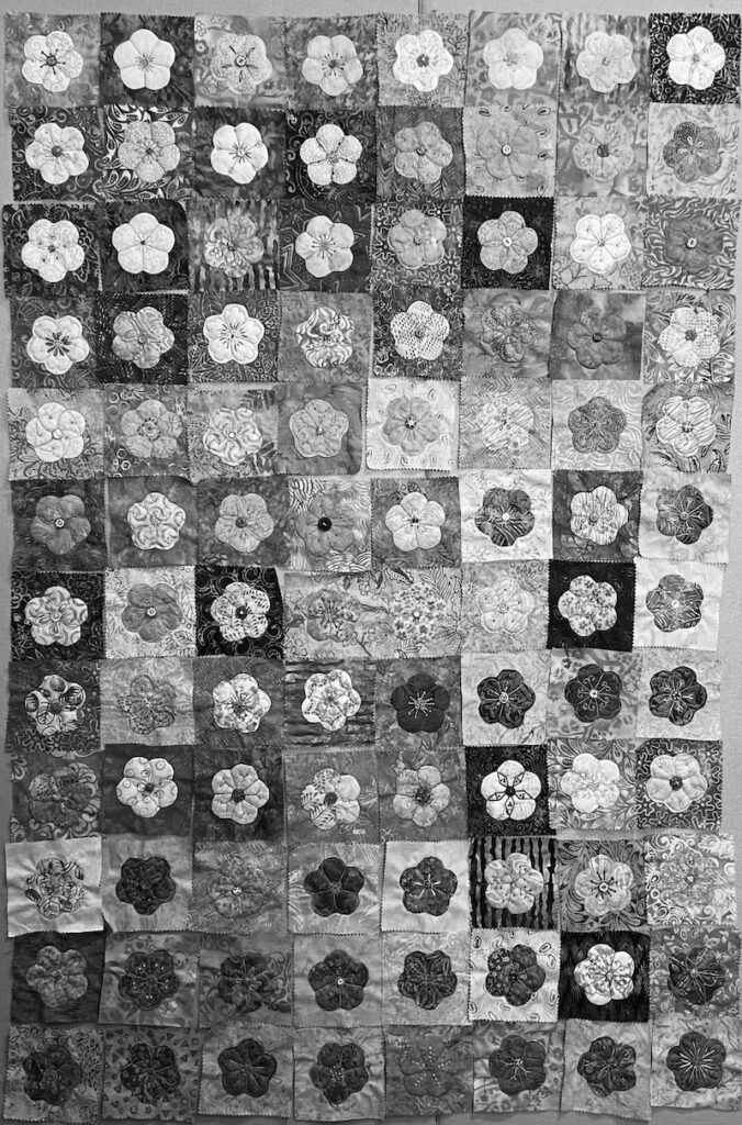 Black and white photo of flower quilt blocks showing the value of the flowers and backgrounds.